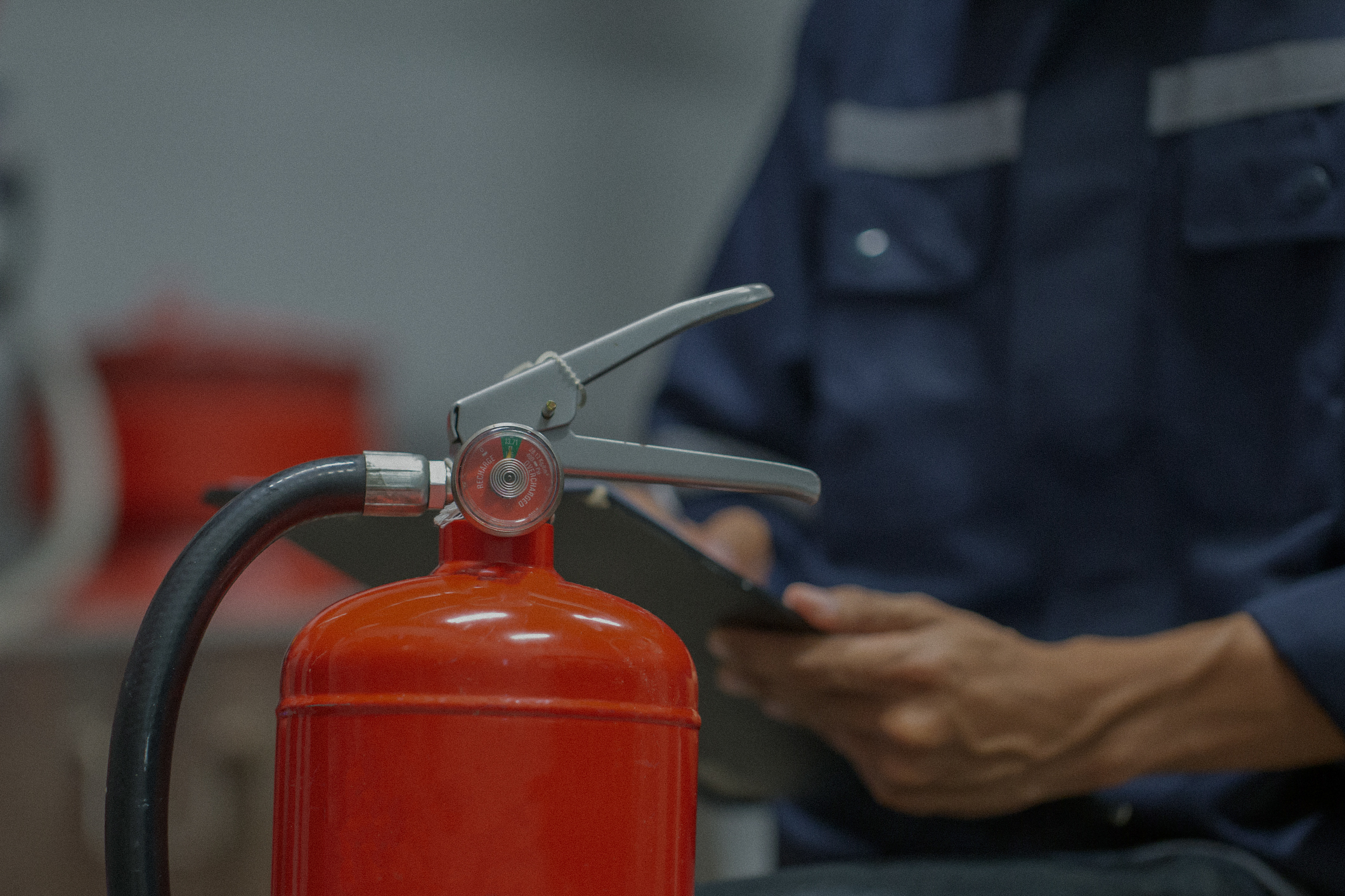 Engineer are checking and inspection a fire extinguishers tank in the fire control room for safety training and fire prevention.